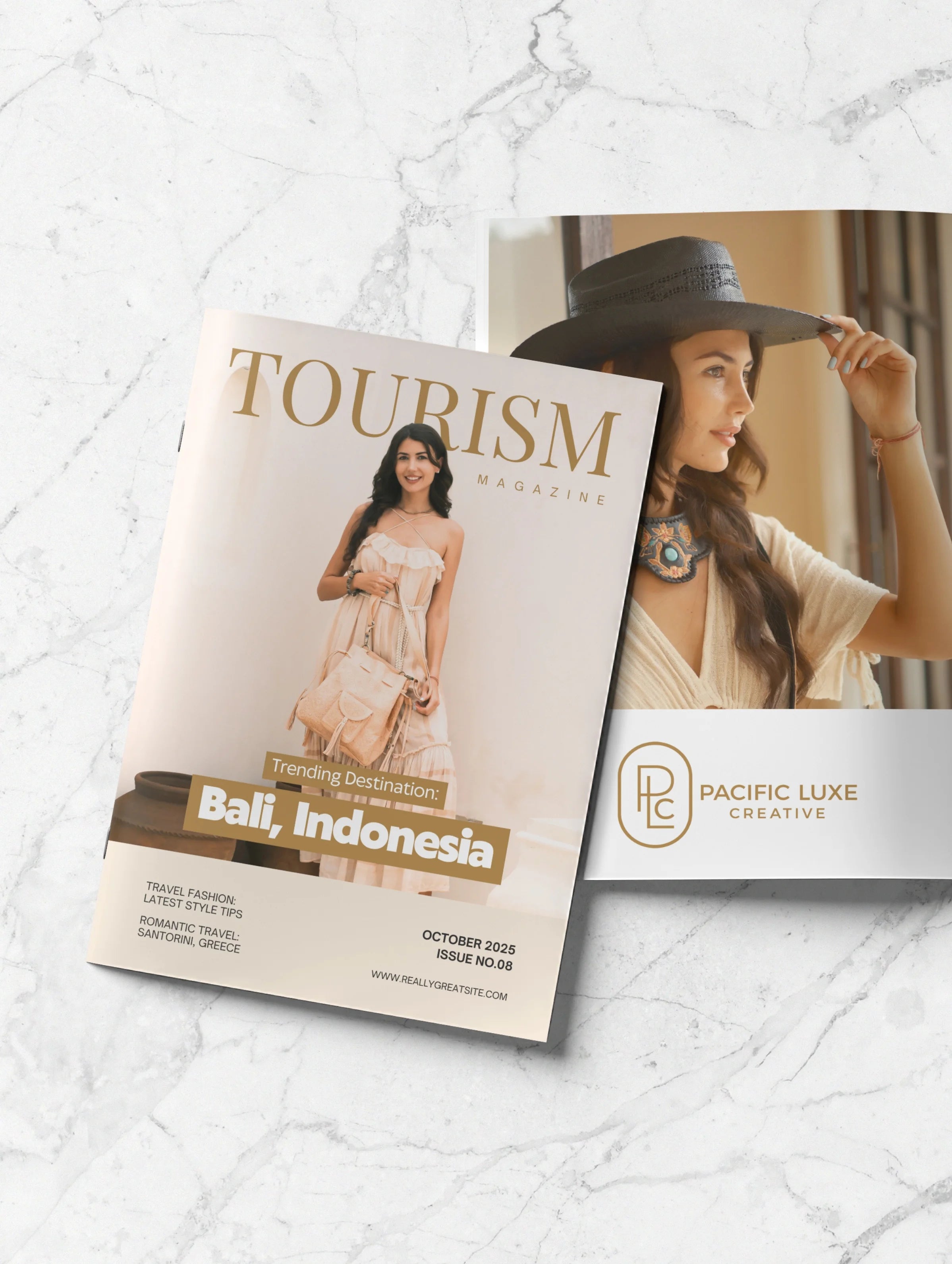 Luxury product photography by Pacific Luxe Creative showcasing Tourism Magazine cover styled on marble with elegant coastal tones.