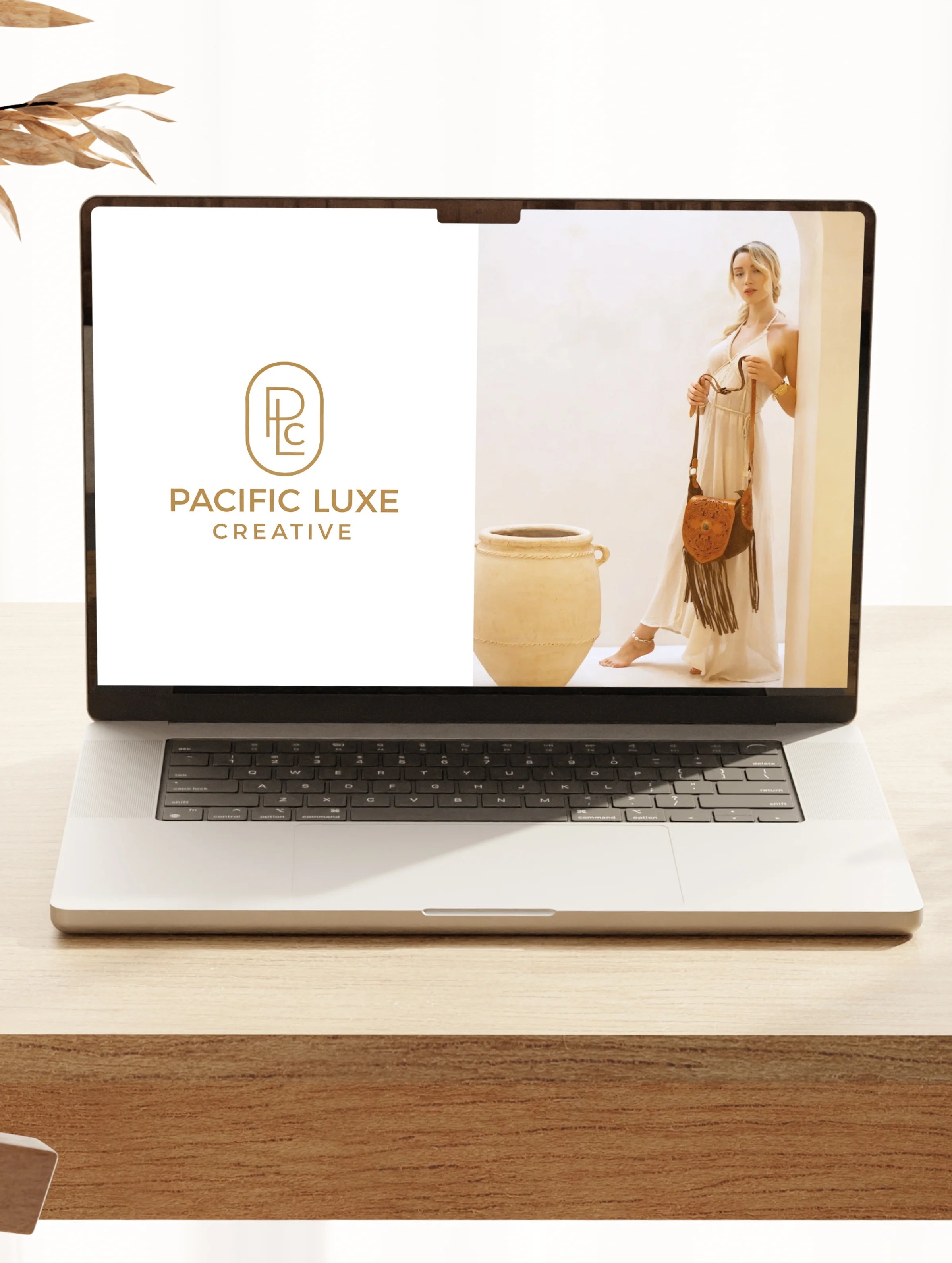 Luxury product photography by Pacific Luxe Creative showing laptop on timber surface with refined Perth aesthetic.