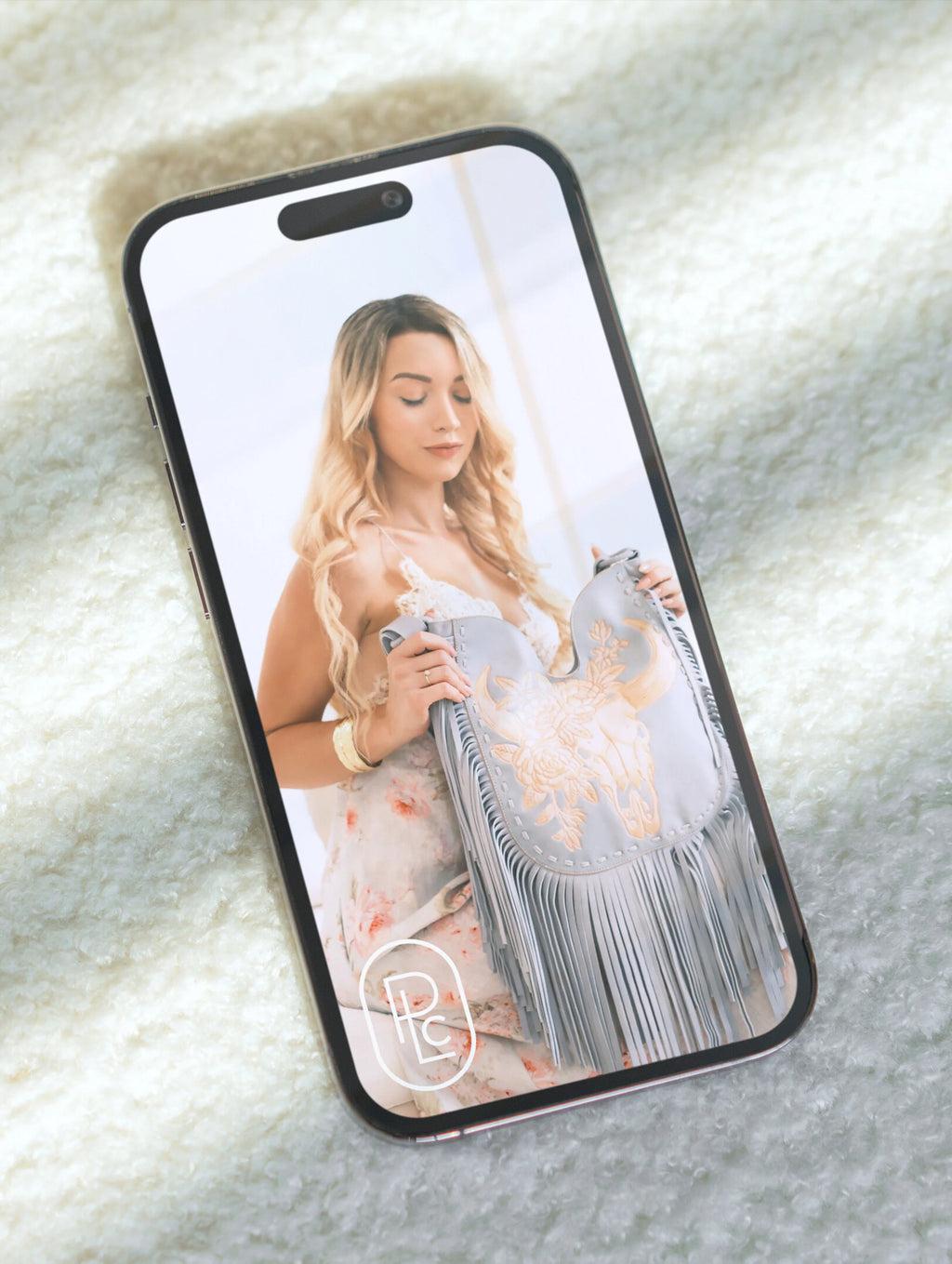 Luxury brand photography by Pacific Luxe Creative showcasing phone case with feminine imagery on natural Perth-inspired texture.