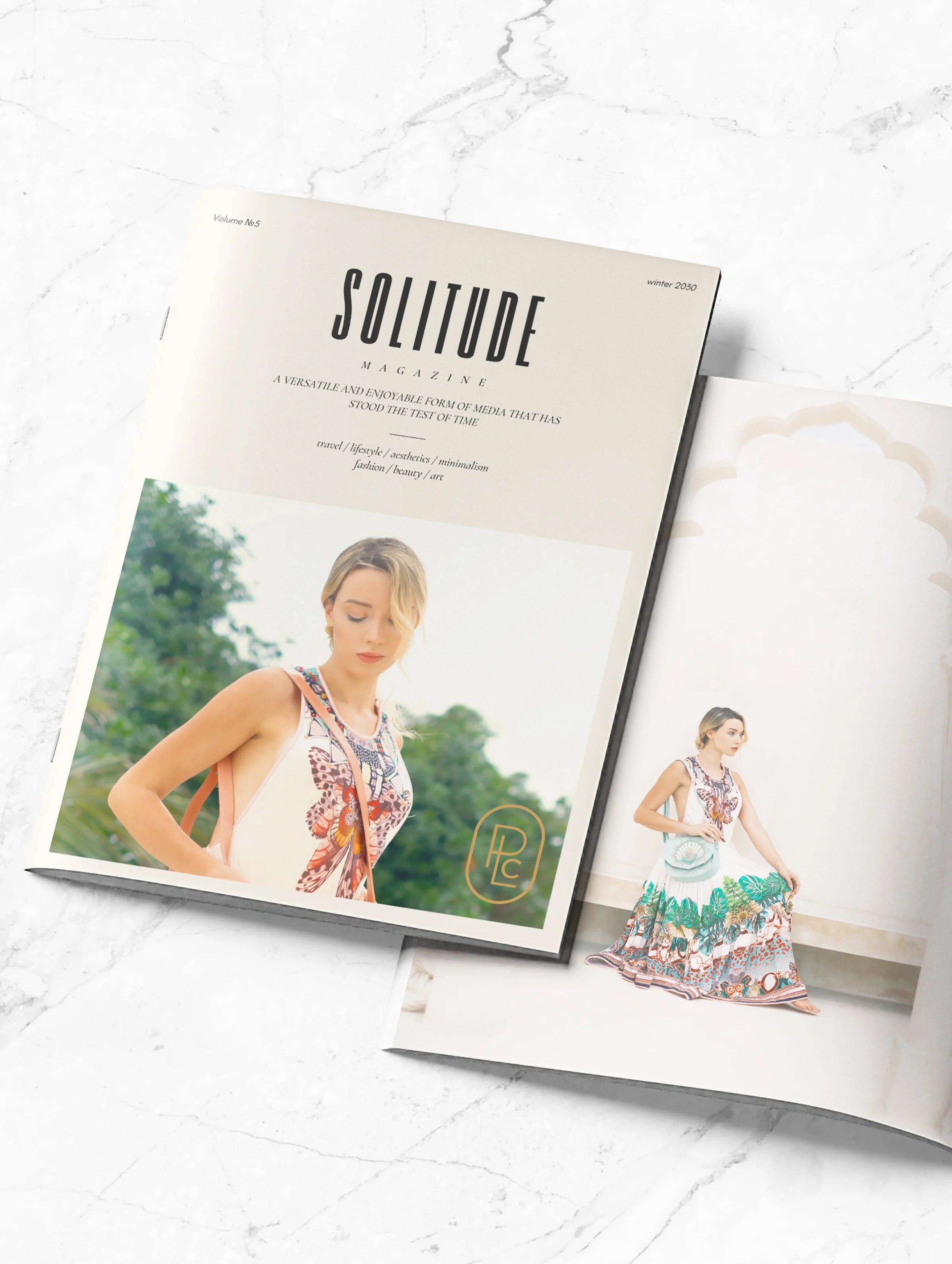 Luxe product photography by Pacific Luxe Creative featuring ‘Solitude’ magazine on marble, captured with Perth-inspired elegance