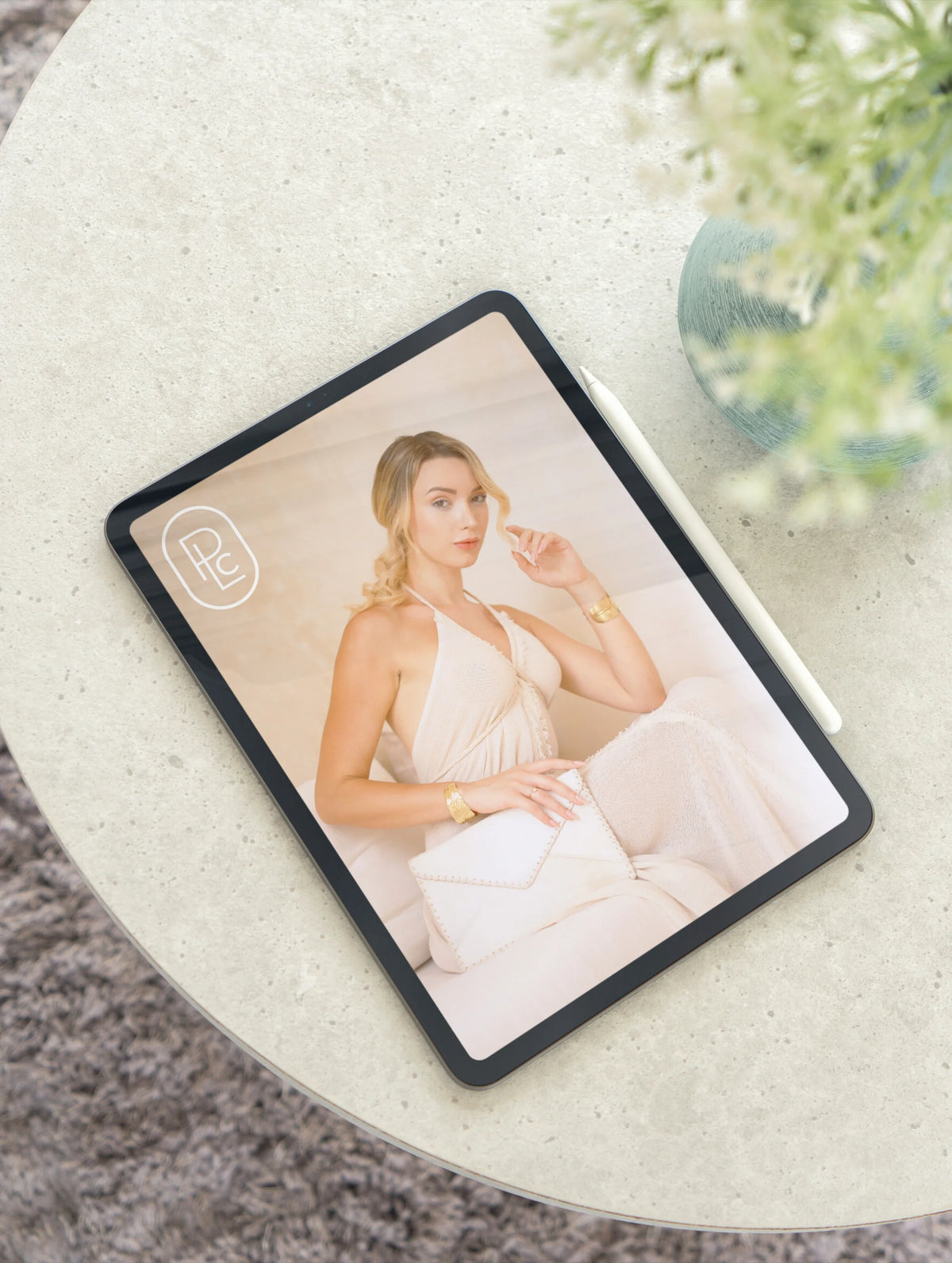 Creative brand imagery from Pacific Luxe Creative  tablet on white surface showing woman in white dress with serene Karri Sapling glow.