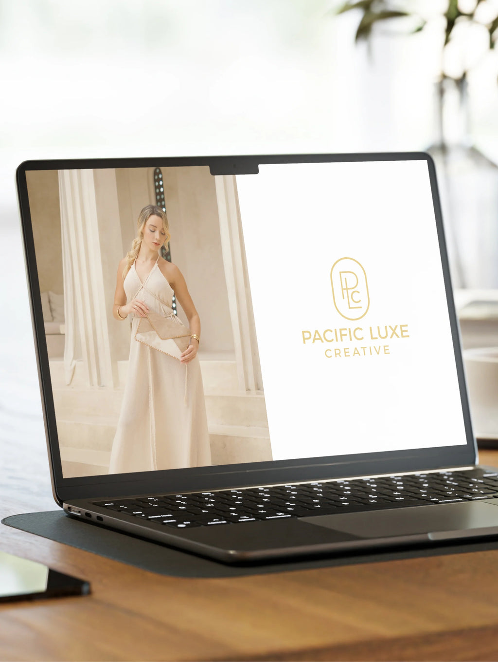 Creative Bali-inspired imagery by Pacific Luxe Creative laptop showcasing brand logo and woman in white dress under gentle Karri Sapling glow.