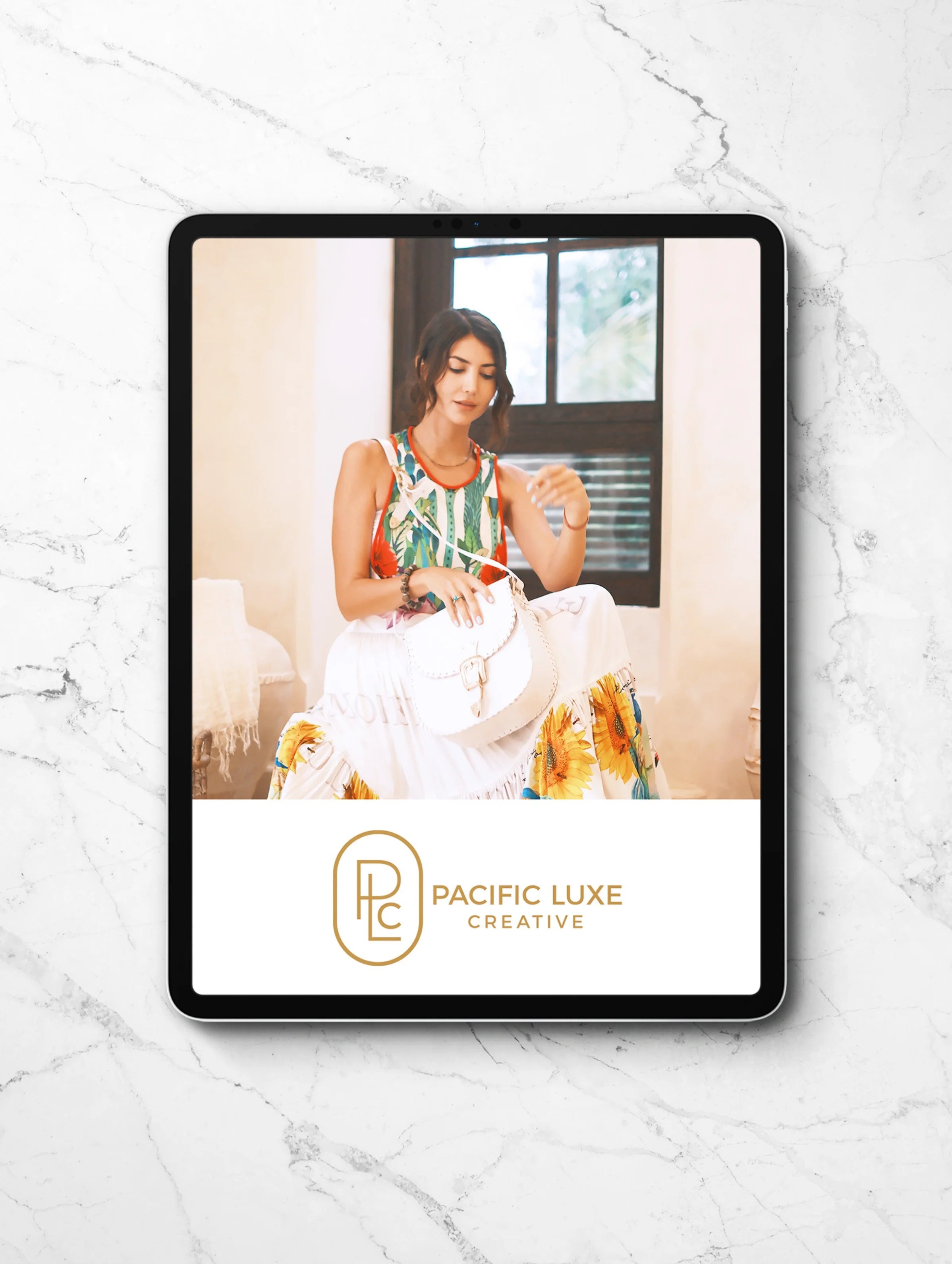 Pacific Luxe Creative luxury branding tablet on marble highlighting island-inspired imagery with a refined palm breeze vibes