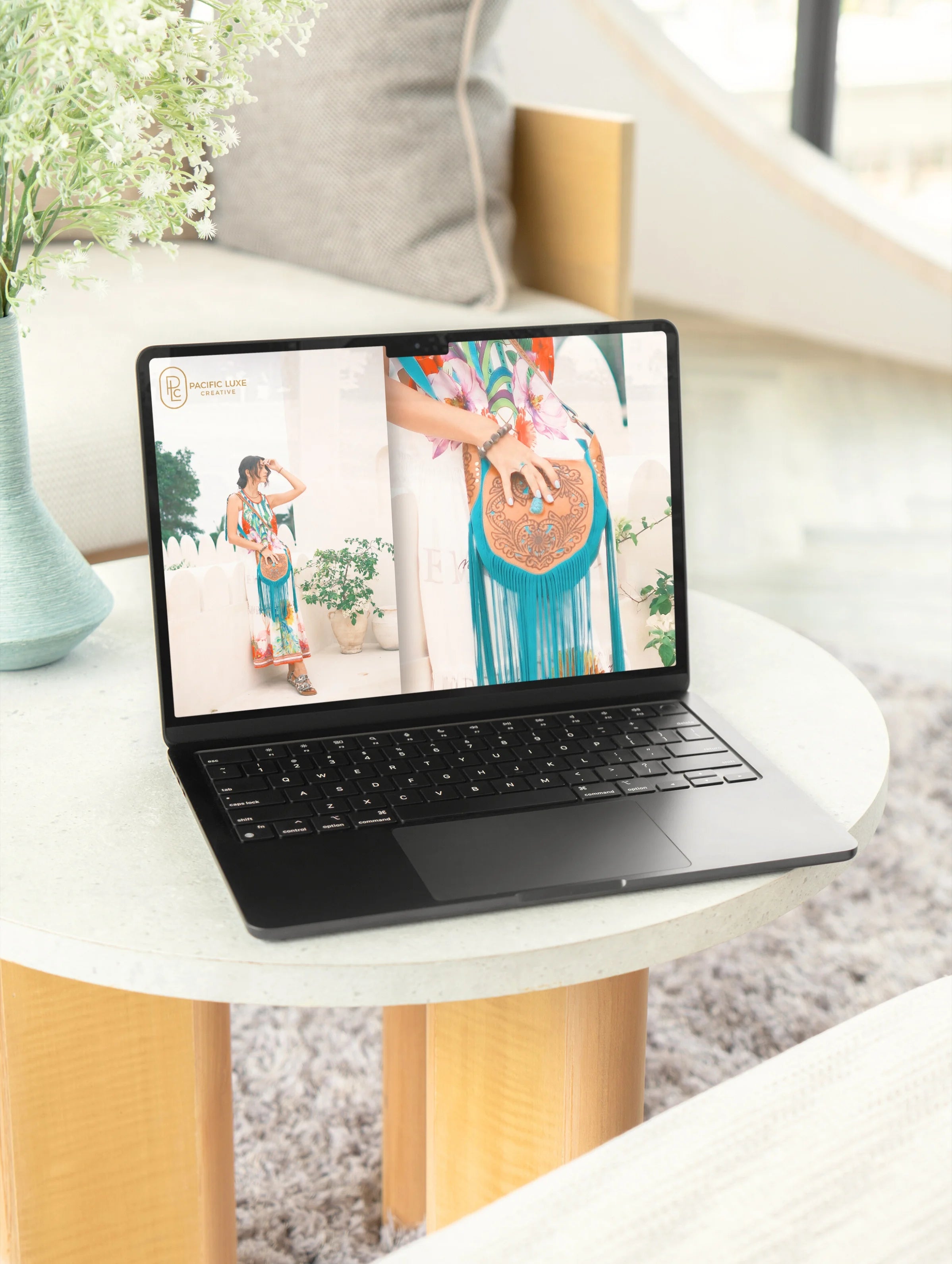 Luxe product photography by Pacific Luxe Creative featuring a laptop with elegant island-inspired imagery of a woman in a dress under soft coastal light.