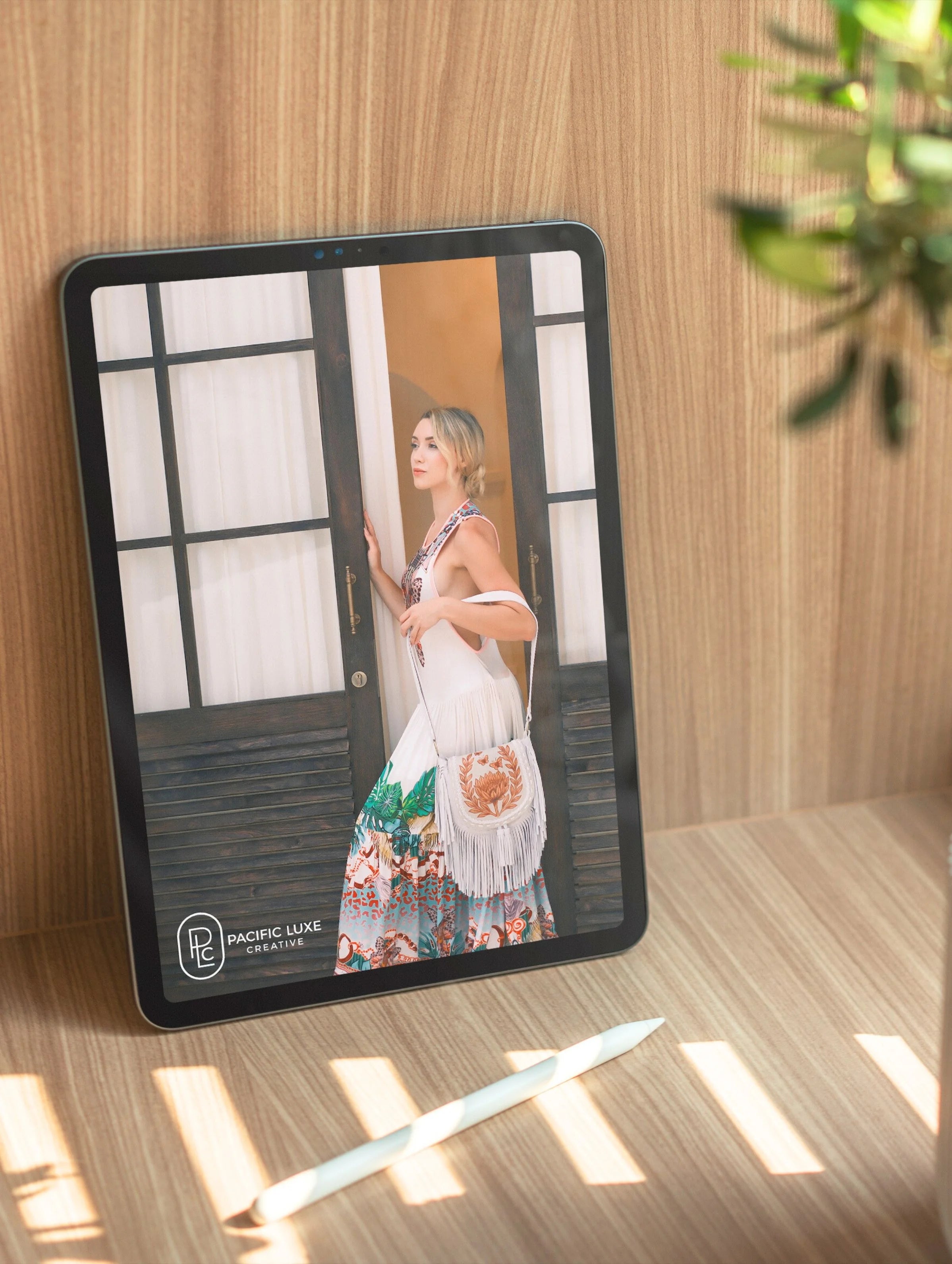 Elegant product photography from Pacific Luxe Creative tablet showcasing woman in dress with Bali-inspired light and natural luxury aesthetic.