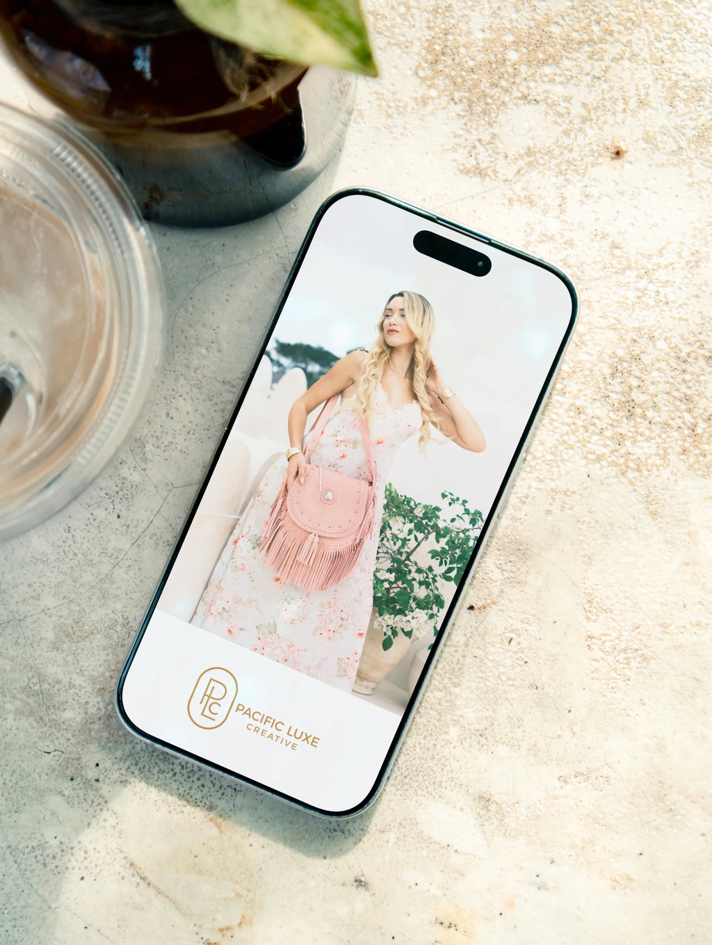 Elegant product photography from Pacific Luxe Creative phone featuring woman in dress and pink bag, styled in serene Bali-inspired light.